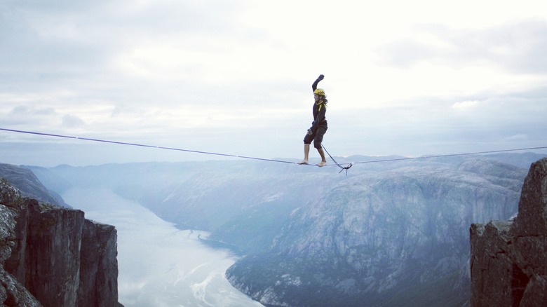 Person walking on tightrope 