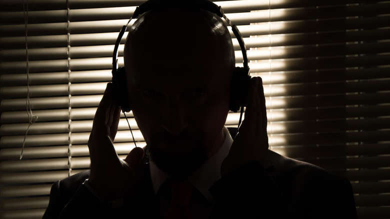 shadowy figure listening on headphones