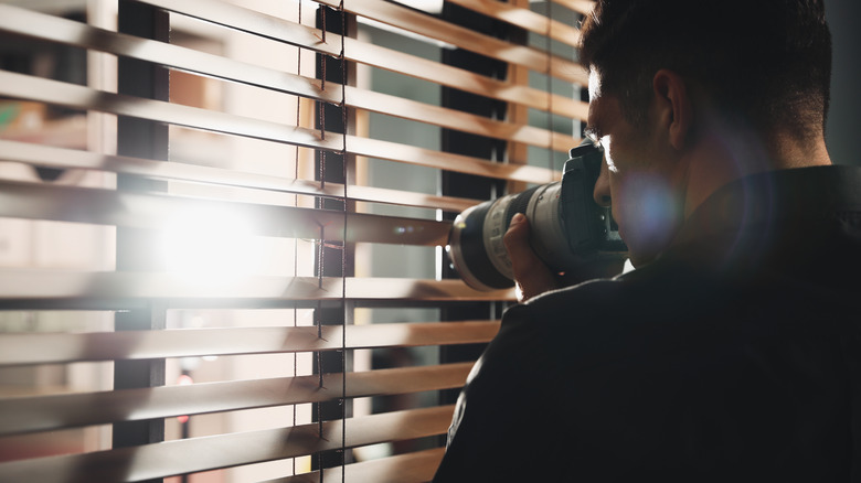 guy taking pictures through a window