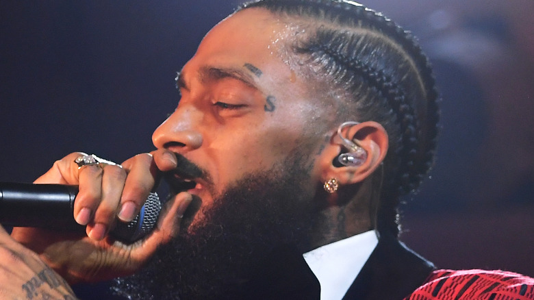 Nipsey Hussle singing into mic