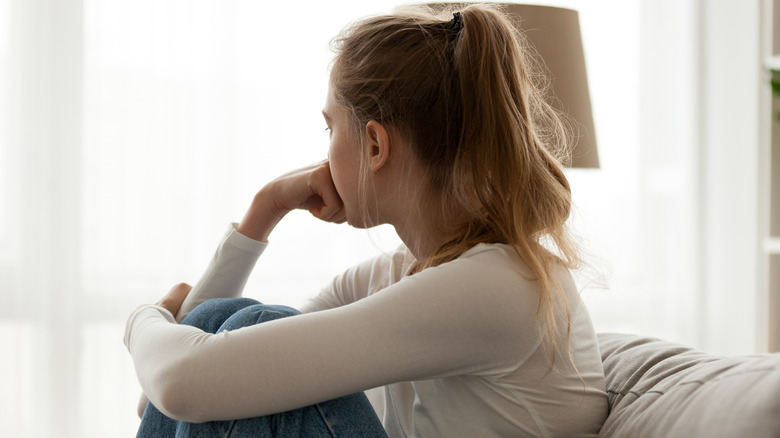 woman on couch, looking away