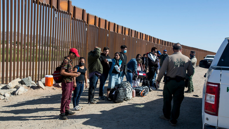 US border wall with detainees