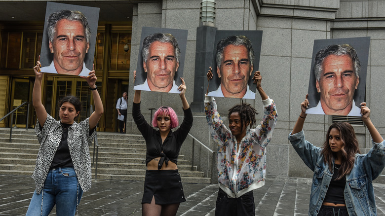 Epstein's mugshot held by protestors outside the courthouse