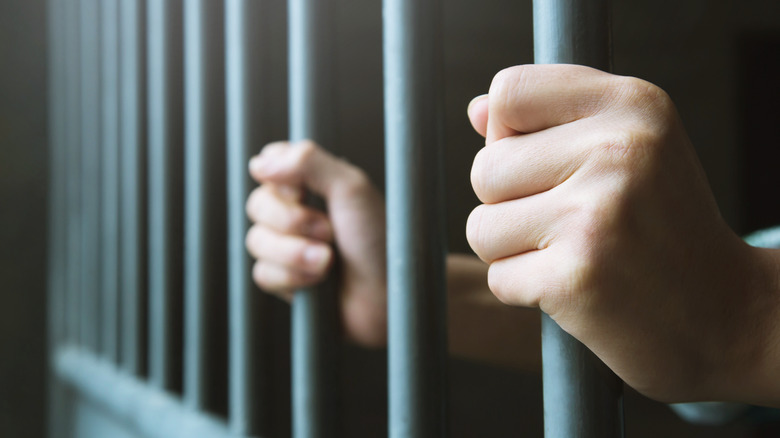 hands on Prison bars