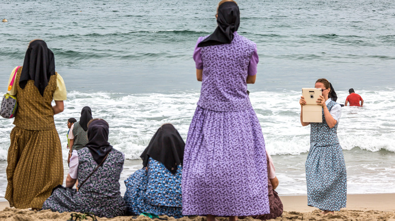 Amish women on a beach