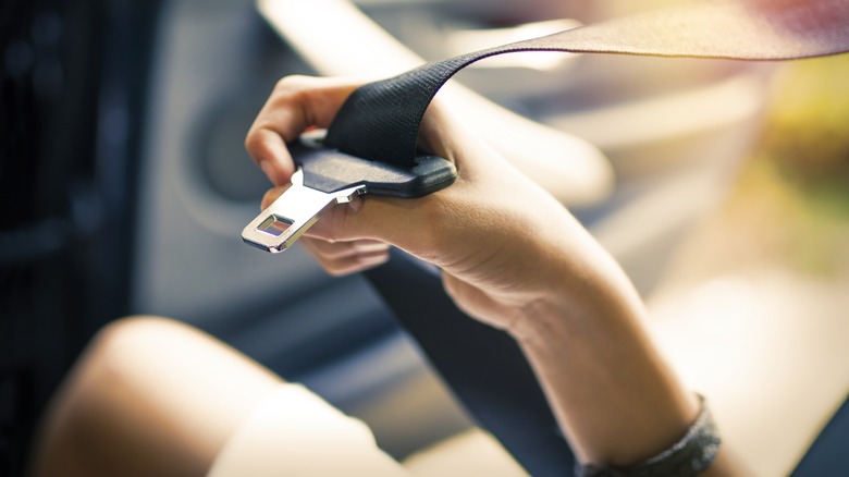 Woman holding a seatbelt 