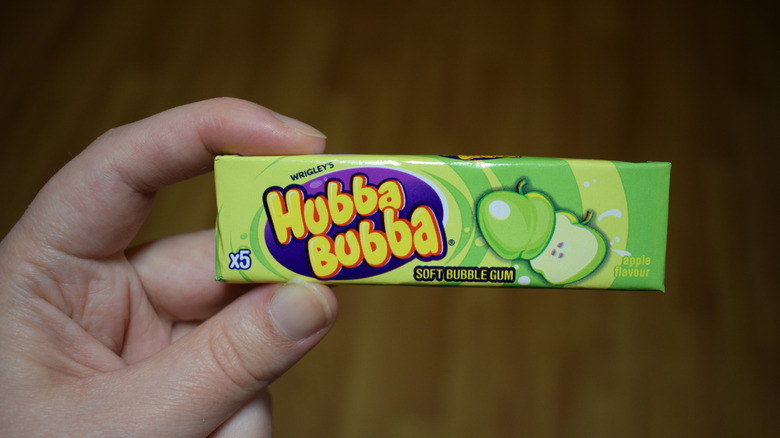 Man holding a pack of Hubba Bubba gum